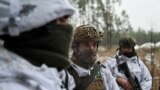 Ukrainian servicemen in snow camouflage take part in a military training in an undisclosed location in the Kharkiv region, Ukraine, on Dec. 1, 2023.