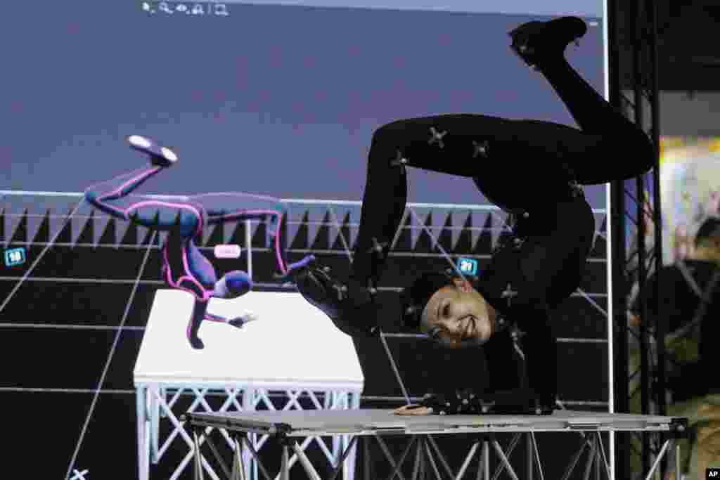 A dancer demonstrates at the OptiTrack booth with its motion tracking device on the first day mainly for the media and businesses during the Game Show at the Makuhari Messe convention center in Chiba, east of Tokyo, Japan.