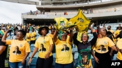 Supporters wearing t-shirts depicting South African President Cyril Ramaphosa, sing and dance at the African National Congress (ANC) Election Manifesto launch at the Moses Mabhida Stadium in Durban on February 24, 2024. 