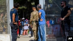 Migrants wait to be transferred from Lampedusa Island, Italy, Sept. 15, 2023. Thousands of migrants and refugees have landed on the island after crossing the Mediterranean Sea from Tunisia, overwhelming local authorities and aid organizations.