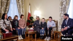 Qatar ambassador to Russia, Sheikh Ahmed bin Nasser al-Thani and Alexey Ghazaryan of the Russian Office of the Commissioner for Children's Rights, meet Ukrainian children and their family members at the Qatari embassy in Moscow, Dec. 5, 2023.