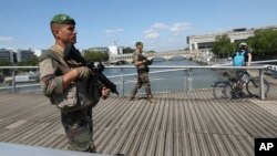 Soldiers patrol on a footbridge over the Seine river ahead of the 2024 Summer Olympics, in Paris, France, July 17, 2024.