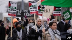 Pro-Palestinian demonstrators march during a visit by US President Joe Biden in Warren, Mich., Feb. 1, 2024.