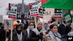 Pro-Palestinian demonstrators march during a visit by US President Joe Biden in Warren, Mich., Feb. 1, 2024. 