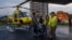 The body of a victim of a helicopter crash is carried out of a chopper in Kathmandu, Nepal, July 11, 2023. Five Mexican tourists and a Nepalese pilot have died when it crashed near Mount Everest in Nepal.