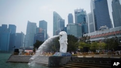 FILE - The Merlion statue spouts water at a park with the background of a business district in Singapore, Sept, 21, 2019. A Singaporean man is scheduled to be hanged next week for abetting an attempt to smuggle cannabis into the island-state, activists said, April 20, 2023. 