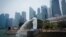FILE - The Merlion statue spouts water at a park with the background of a business district in Singapore, Sept, 21, 2019. A Singaporean man is scheduled to be hanged next week for abetting an attempt to smuggle cannabis into the island-state, activists said, April 20, 2023. 