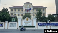 A man drives past a building of the Ministry of Women's Affairs in Phnom Penh on April 9, 2024. (Sim Chansamnang / VOA Khmer)