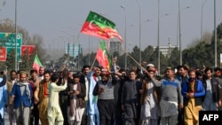 Supporters of Khan's Pakistan Tehreek-e-Insaf (PTI) party block Peshawar to Islamabad highway as they protest against the alleged skewing in Pakistan's national election results, in Peshawar on Feb. 11, 2024. 