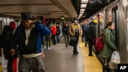 Commuters ride the subway as normal after an earthquake hit in the morning on Friday, April 5, 2024, in New York.