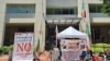 Iranian American activists from the National Solidarity Group for Iran protest outside Iran's interests section office in Washington on July 5, 2024, denouncing its use as a ballot station for the runoff vote of Iran's presidential election. (Courtesy of NSGIran)