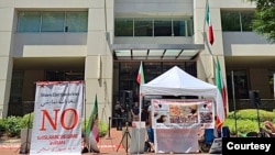 Iranian American activists from the National Solidarity Group for Iran protest outside Iran's interests section office in Washington on July 5, 2024, denouncing its use as a ballot station for the runoff vote of Iran's presidential election. (Courtesy of NSGIran)