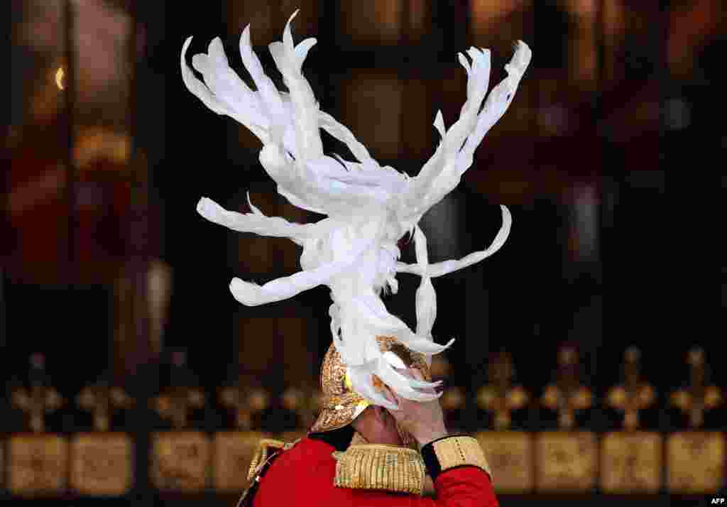 A member of The King's Body Guards of the Honourable Corps of Gentlemen at Arms arrives for the State Opening of Parliament at the Houses of Parliament, in London.