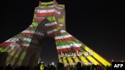 Azadi (Freedom) Tower is illuminated with pictures of Iranian late supreme leader Ayatollah Ruhollah Khomeini and Iran's national flag during a ceremony of the 45th anniversary of the Islamic Revolution, in Tehran, Feb. 10, 2024. 