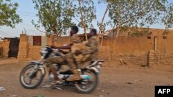 Sudanese army soldiers ride a motorcycle in Khartoum, on June 26, 2023. 