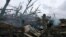 FILE - A Ukrainian soldier fires toward Russian positions at the front line near Avdiivka, an eastern city where fierce battles against Russian forces have been taking place, in the Donetsk region, Ukraine, on April 28, 2023. 