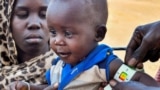 FILE- A child is examined for malnutrition in Renk County, Upper Nile state, South Sudan April 30, 2023. REUTERS/Jok Solomun REFILE - QUALITY REPEAT TPX IMAGES OF THE DAY.