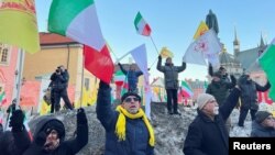 Protesters celebrate the guilty verdict of Hamid Noury in Stockholm, Dec. 19, 2023.