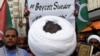 Pakistani Shi'ite Muslim supporters of Majlis-e-Wahdat-e-Muslimeen (MWM) carry a poster, as they listen to the speech during a protest, to denounce the desecration of Koran outside a mosque in the Swedish capital Stockholm, in Karachi, July 2, 2023.