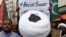 Pakistani Shi'ite Muslim supporters of Majlis-e-Wahdat-e-Muslimeen (MWM) carry a poster, as they listen to the speech during a protest, to denounce the desecration of Koran outside a mosque in the Swedish capital Stockholm, in Karachi, July 2, 2023.