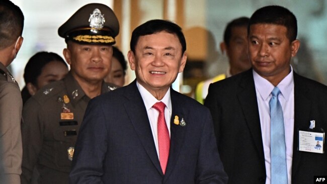 FILE -- Former Thai Prime Minister Thaksin Shinawatra, center, arrives to greet his supporters after landing at Don Mueang Airport in Bangkok, Aug. 22, 2023. Thai officials said he would be released from jail on Feb. 18, 2024.
