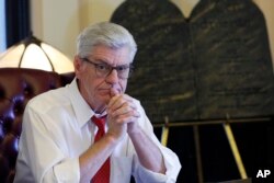 FILE - During his final week in office, Mississippi Republican Gov. Phil Bryant ponders a question in the state Capitol in Jackson, Jan. 8, 2020.