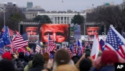 Pristalice tadašnjeg predsjednika Donalda Trumpa okupljaju se u Washingtonu, 6. januara 2021., s Trumpovom slikom prikazanom na megatronima.