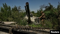 A Ukrainian serviceman inspects a turret of a destroyed Russian BMP-3 infantry fighting vehicle in the recently liberated village of Novodarivka, amid Russia's attack on Ukraine, in Zaporizhzhia region, Ukraine, July 21, 2023.