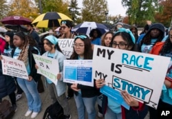 People rally as the Supreme Court hears oral arguments on two cases that could decide the future of affirmative action in college admissions, in Washington, Oct. 31, 2022.