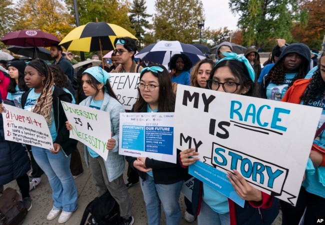 People rally as the Supreme Court hears oral arguments on two cases that could decide the future of affirmative action in college admissions, in Washington, Oct. 31, 2022.