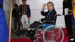 FILE - Ecuadorian President Guillermo Lasso waves to the press in Quito, Ecuador, March 6, 2023.