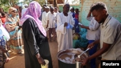 Volunteers distribute food to residents and displaced people in Omdurman, Sudan, March 8, 2024.