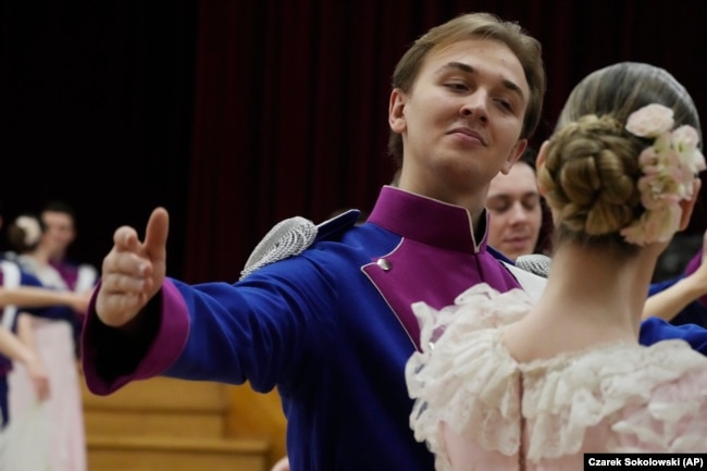 Dancers of the University of Warsaw dance Poland's national polonaise dance in 18th century costumes during dress rehearsal in Warsaw, Poland, on Feb. 8, 2024. (AP Photo/Czarek Sokolowski)