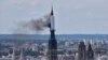 Fire in towering spire of medieval cathedral in French city of Rouen is under control