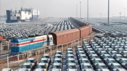 ars wait to be loaded onto a ship for export at the port in Yantai, in Chinas eastern Shandong province on January 2, 2024. 