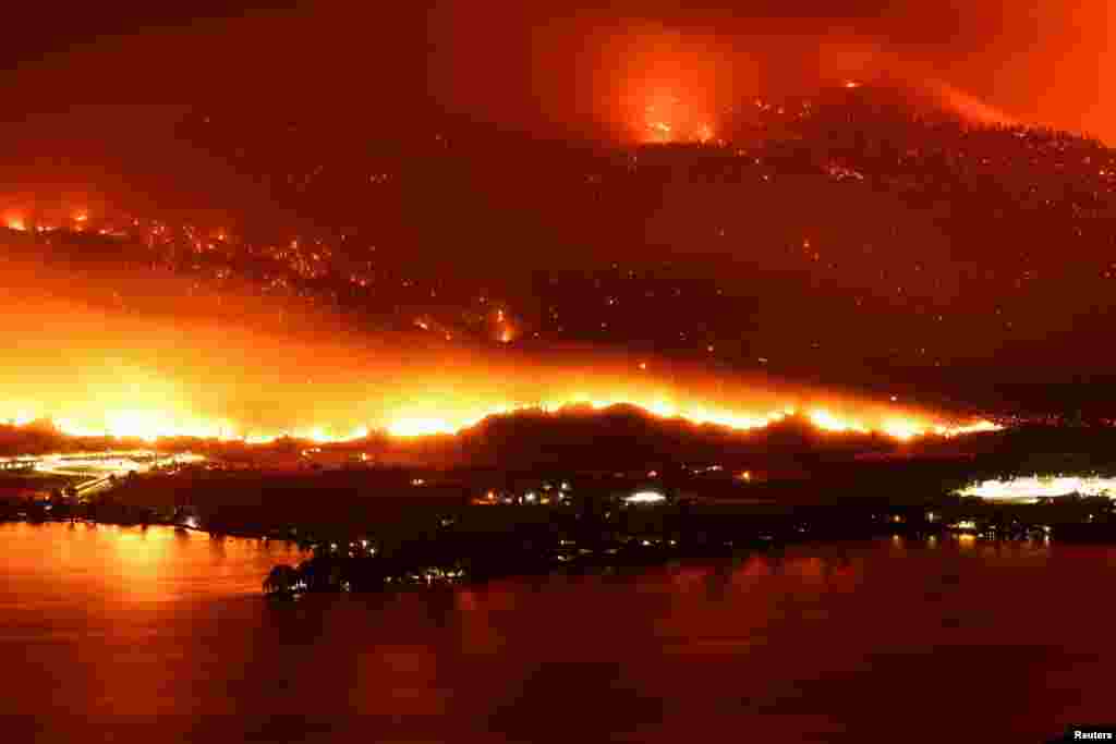 A long exposure image shows the Eagle Bluffs Wildfire, which crossed the border from the U.S. state of Washington, and prompted evacuation orders in Osoyoos, British Columbia, Canada.