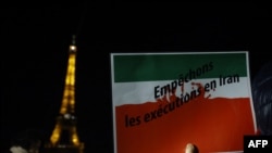 Seorang demontran membawa poster bertuliskan "Hentikan eksekusi di Iran" dalam aksi protes di Paris, Prancis, pada 16 Januari 2023, yang menyerukan dukungan kepada para warga Iran. (Foto: AFP/Ludovic Marin)