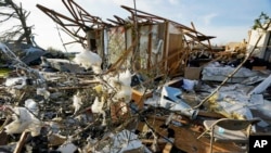 Debris is what remains from a house destroyed by the Friday night tornado in Rolling Folk, Miss., March 26, 2023. The area is quiet after families, friends and neighbors spent most of Saturday trying to salvage their possessions.