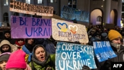 FILE - Demonstrators take part in a protest in front of the European Commission representation in Warsaw demanding more restrictive sanctions against Russia and arms supplies for Ukraine, Jan. 8, 2024.