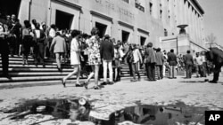 FILE - "Earth Day" demonstrators trying to dramatize environmental pollution conclude their rally at the Interior Department in Washington April 22, 1970, leaving spilled oil in their wake. The oil was used to protest pollution by off-shore oil drilling. (AP Photo).