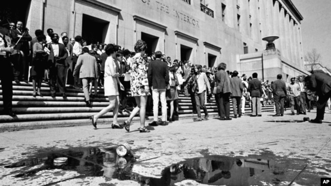 FILE - "Earth Day" demonstrators trying to dramatize environmental pollution conclude their rally at the Interior Department in Washington April 22, 1970, leaving spilled oil in their wake. The oil was used to protest pollution by off-shore oil drilling. (AP Photo).