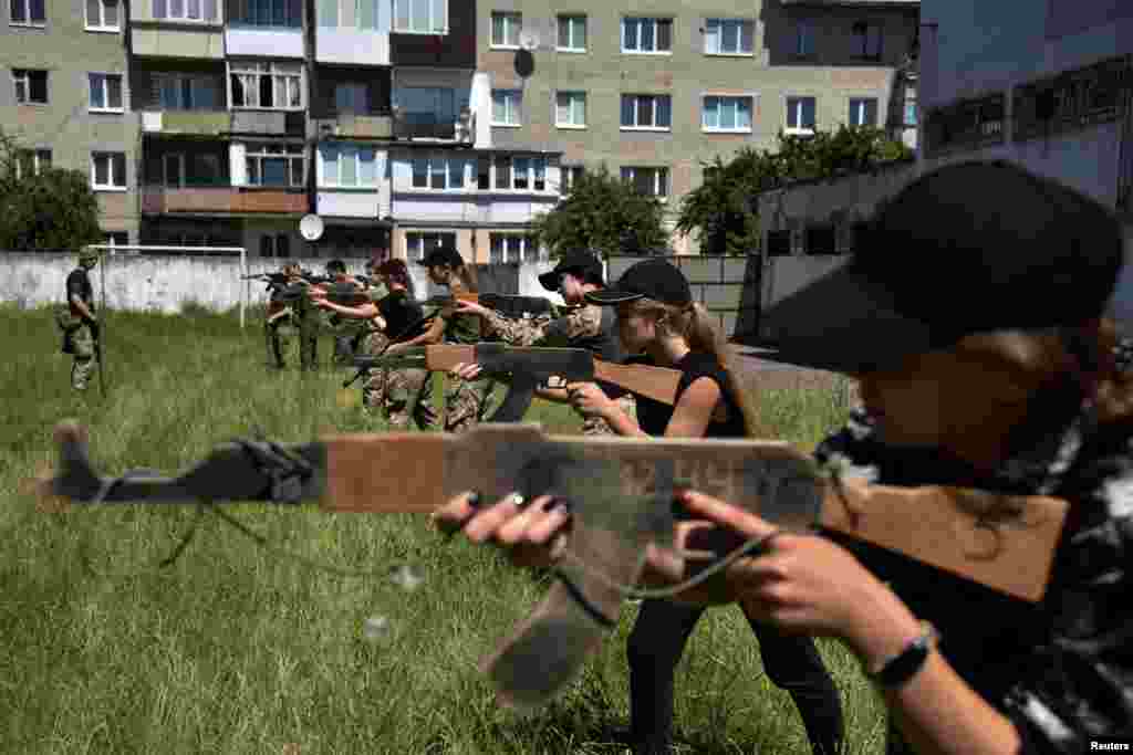 Teenagers attend a military training conducted by members of the Ukrainian Volunteer Corps in Lviv region, Ukraine.