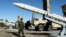 Iran's Defense Minister Brigadier General Mohammad-Reza Ashtiani walks near an Iranian missile during an unveiling ceremony in Tehran, Iran, in this picture obtained on Feb. 17, 2024. (Iran's Defense Ministry/WANA via Reuters)
