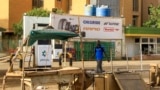 FILE: A man walks past an abandoned stall near a petrol station in the south of conflict-emptied Khartoum on April 17, 2023.