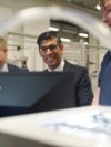 Britain's Prime Minister Rishi Sunak, center, and Grant Shapps, Secretary of State for Energy Security and Net Zero, left, are shown robotics by an apprentice, during a visit to the UK Atomic Energy Authority, Culham Science Centre, in Abingdon, England, March 30, 2023. 