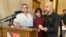 Parents Devon and Robert Dolney, of Fargo, ND, stand with their 12-year-old, Tate, during a press conference,  Sept. 14, 2023, at the state Capitol in Bismarck, ND. 