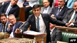A handout photograph taken and released by the UK Parliament shows Britain's Prime Minister Rishi Sunak speaking at the House of Commons in London, June 28, 2023. 