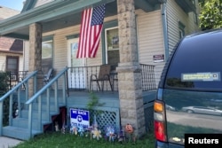 A US flag hangs on the porch and a "Proud parent of a U.S. Army soldier" sticker adorns the car outside the home of 23-year-old Private Travis King's mother in Racine, Wisconsin, July 19, 2023.
