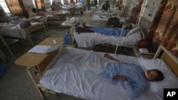 Injured people lie on the bed at a hospital after Sunday's suicide bomber attack, in the Bajaur district of Khyber Pakhtunkhwa, Pakistan, July 31, 2023.