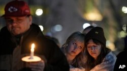People attend a vigil for victims of a shooting at a Kansas City Chiefs Super Bowl victory rally in Kansas City, Missouri, Feb. 15, 2024. More than 20 people were injured and one woman killed in the shooting near the end of the rally at Union Station.